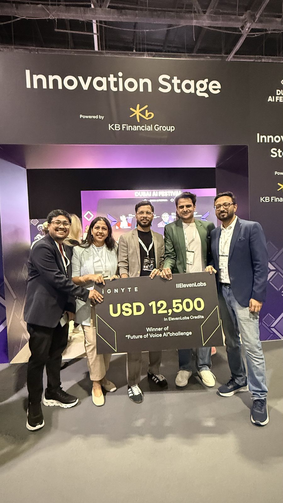 Team Mizan holding the winner's cheque under the Innovation Stage sign
