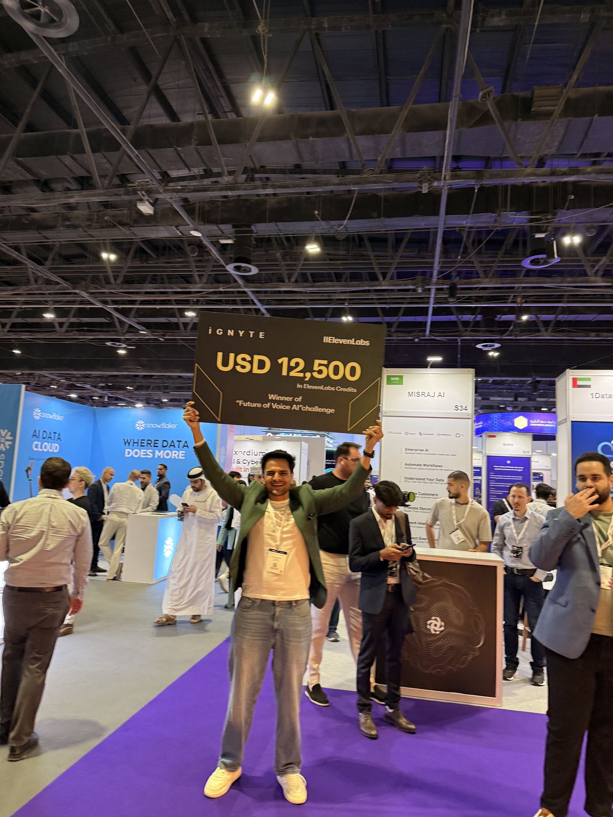 Narayan holding the winner's board up on the festival floor